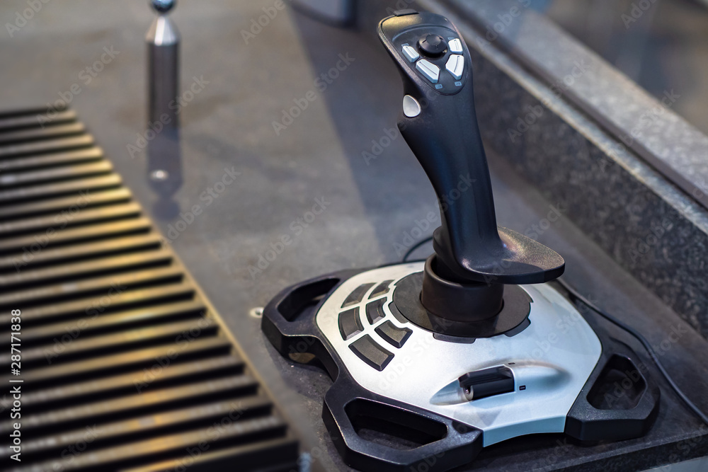 Poster joystick to control industrial robot. remote control of production. automation of the working proces