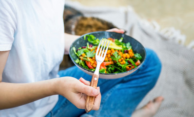 Clean eating, vegan healthy salad bowl closeup , woman holding salad bowl, plant based healthy diet...