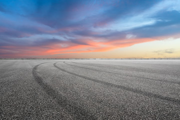 Empty race track road and beautiful sky clouds at sunset