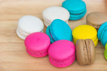 Fototapeta na wymiar Colorful Macaroons in dish on wooden table