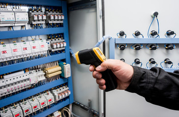 Technician use infrared thermal imaging camera to check temperature at fuse-box