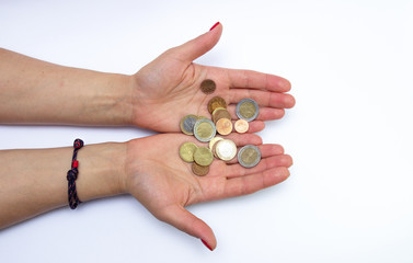 metal money in female hands isolated on a white background. Business concept, savings, calculation.