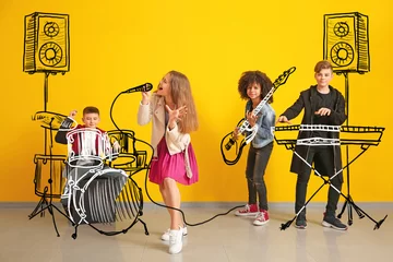 Poster Teenage musicians with drawing instruments playing against color wall © Pixel-Shot
