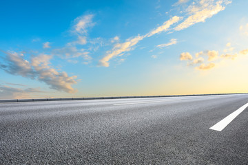 Empty asphalt highway and beautiful sky clouds at sunset