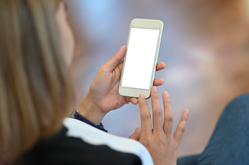 Female's hands holding mockup smartphone.