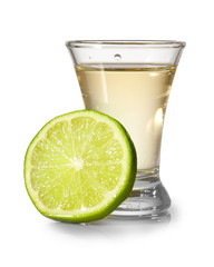Shot of tasty tequila with lime on light background