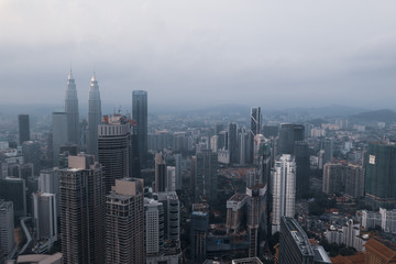 Naklejka na ściany i meble Aerial drone view of Kuala Lumpur city skyline during cloudy day