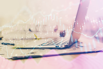 Forex Chart hologram on table with computer background. Multi exposure. Concept of financial markets.