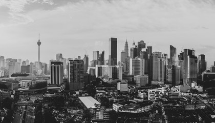 Aerial view of Kuala Lumpur city skyline during cloudy day, Malaysia - black and white photo