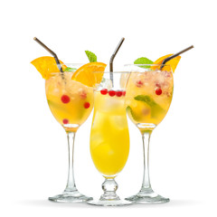 Glasses of cold cocktails on color background