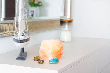 himalayan pink salt lamp on white table