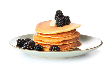 Plate with tasty pancakes and berries on white background