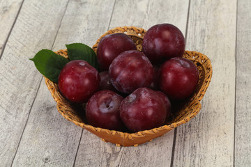 Plum heap in the wooden basket