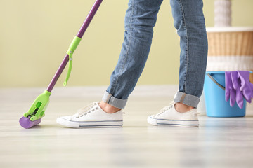 Woman cleaning floor in room