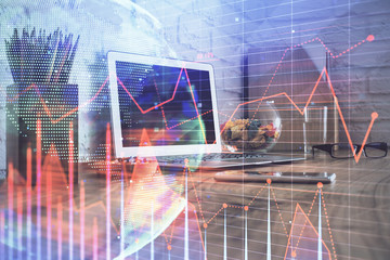 Double exposure of chart and financial info and work space with computer background. Concept of...