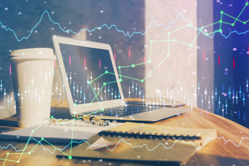 Stock market chart hologram drawn on personal computer background. Multi exposure. Concept of investment.