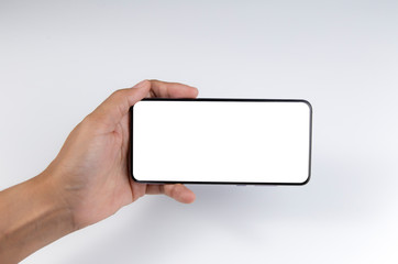 Hand holding the black smartphone with blank screen isolated on white background with clipping path.