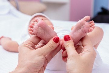 Newborns. Children's legs in the palm of your hand. Close-up.