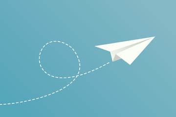 White paper plane flying on blue sky background