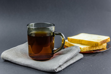 morning tea and toast on a black background