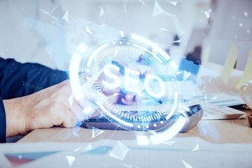 Man hands writing. With double exposure seo drawings.