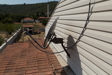 antenna at the house roof with satellite device.