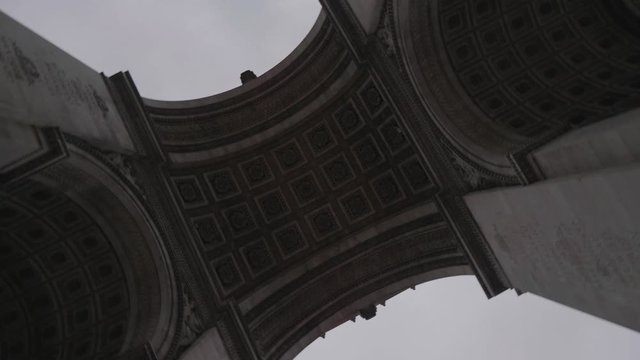 Up rotating shot of the Arc de Triomphe in Paris, France.