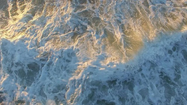 Aerial of ocean wave Cinemagraph on beach at sunrise