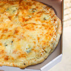 pizza in box (fast food, cheese, tomato sauce and other ingredients) concept, street food. food background. copy space