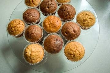 Homemade brown muffins on a cake stand