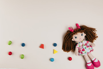 A doll and colourful objects on a white background