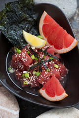 Tuna ceviche with grapefruit, sesame, nori and green onion, close-up, selective focus
