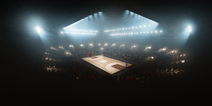 Professional floodlit basketball arena with spectators and fans cheering. High angle view
