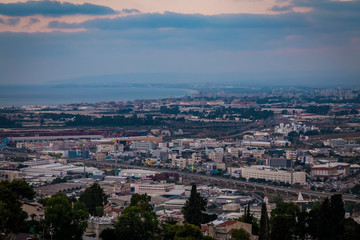 Fototapeta na wymiar View of Haifa city downtrown and harbour port and sea at evening in twilight