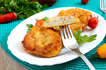 Tasty fried hot sandwiches with minced chicken on a white plate. A piece on a fork.