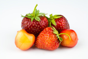 Fresh strawberries and cherries isolated on a white background.
