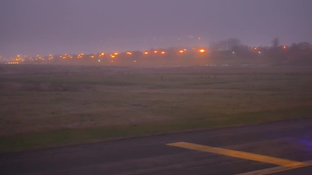 Airplane at the takeoff strip at the Brussels South Charleroi Airport in the early dark morning.
