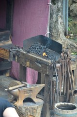 Mediaval forge with a big bellows to fan the flame