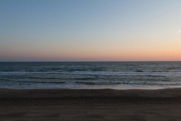 Beautiful sunset on a beach. Twilight on Tyrrhenian sea.