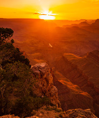 The Colorado River flows through the bottom of the Grand Canyon and can be seen from some vantage...