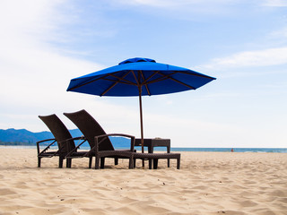 Deck chairs on beach with umbrellaGITAL CAMERA