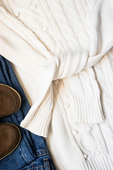 Set of women's autumn, winter clothes - jeans, white pullover oversize, suede brown boots. Fashionable clothes for walks, flat lay