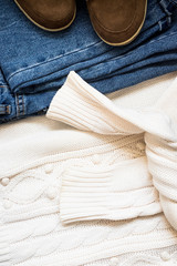 Set of women's autumn, winter clothes - jeans, white pullover oversize, suede brown boots. Fashionable clothes for walks, flat lay