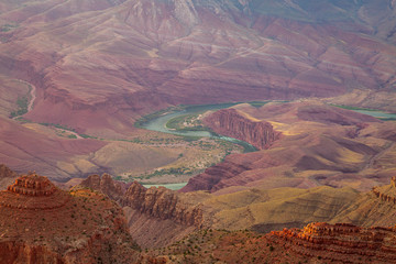 The Colorado River flows through the bottom of the Grand Canyon and can be seen from some vantage...
