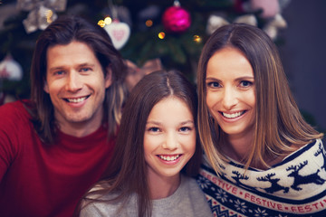 Beautiful family celebrating Christmas at home