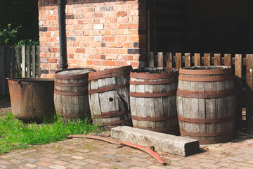 Vintage wooden barrels, left outside in an old yard.
