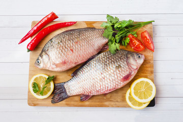 Raw carp fish with spices and vegetables for cooking. The view from the top. Copy space.