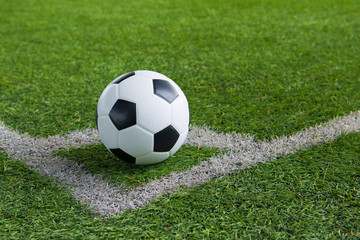 Obraz na płótnie Canvas A ball on the corner line of soccer field.