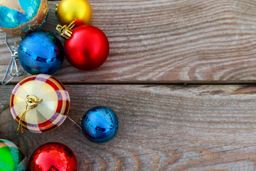 Fototapeta na wymiar Christmas baubles on wooden background. Top view, copy space