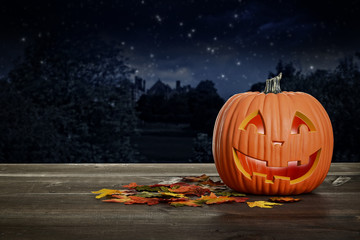 halloween pumpkin glowing on wood table